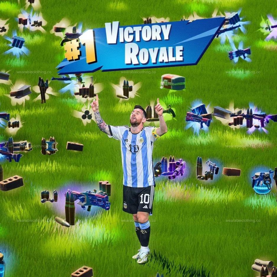 Black T-shirt with Messi doing his celebration, with loot on the ground from Fortnite and a Victory Royale text